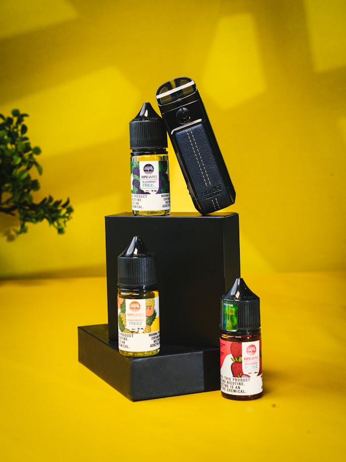 our-story Vape device and e-liquid bottles displayed on a bright yellow background.